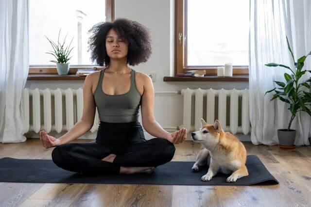 Woman practicing yoga pose indoors, symbolizing relaxation, balance, and home wellness.