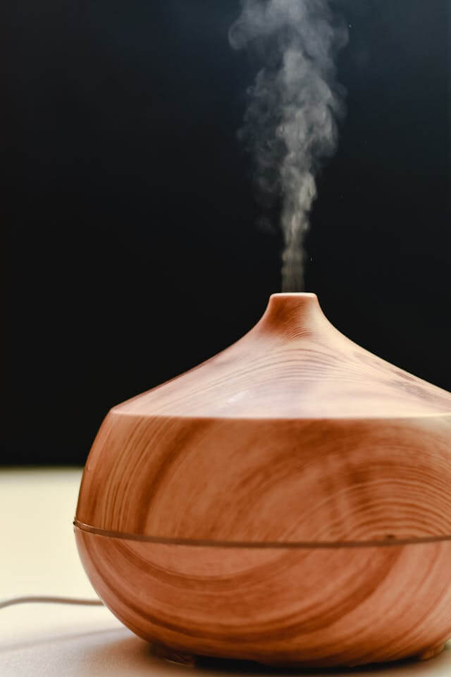 Smart essential oil diffuser emitting aromatic mist with soft LED light, symbolizing home wellness and relaxation technology