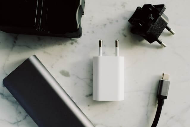 White and black USB cable with charging adapter, compatible with laptops, smartphones, and other devices.