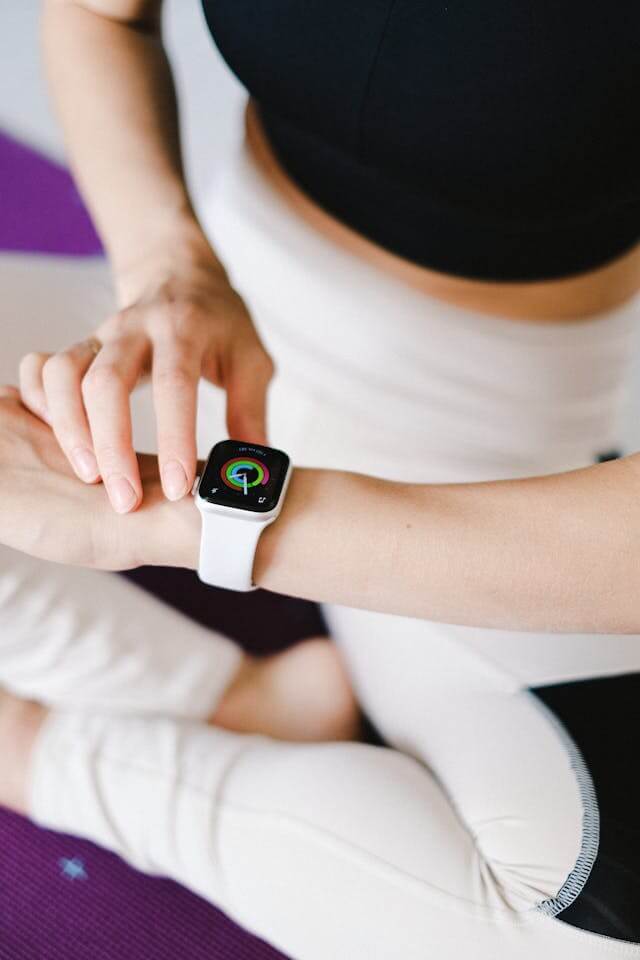 Fitness tracker worn on wrist showing heart rate and step count, representing smart wearable health technology